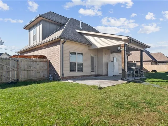 a view of a house with a yard and pathway