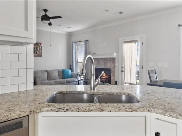 a kitchen with granite countertop a sink and a counter top space