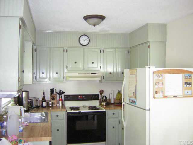 1436 Clermont Road Durham, NC 27713 - Photo 2 of 10 a kitchen with a stove a refrigerator and a sink