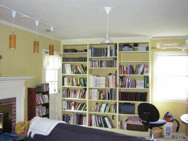 1436 Clermont Road Durham, NC 27713 - Photo 6 of 10 a view of a workspace with bookshelf and a window