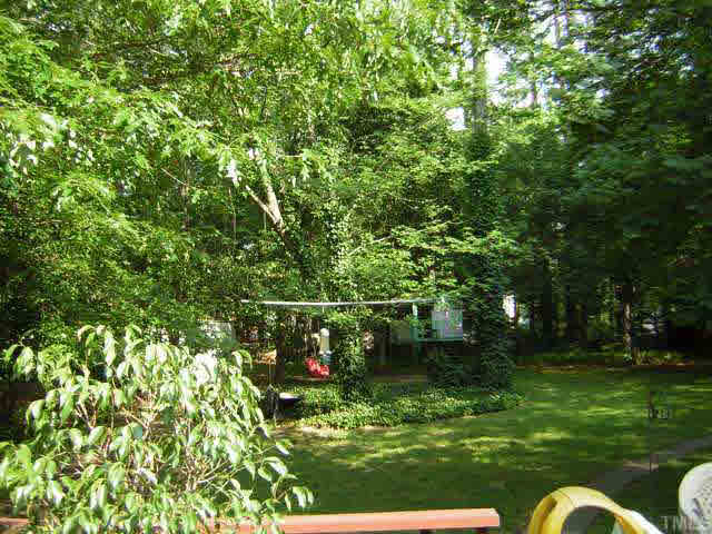 1436 Clermont Road Durham, NC 27713 - Photo 9 of 10 a backyard of a house with lots of green space and fountain