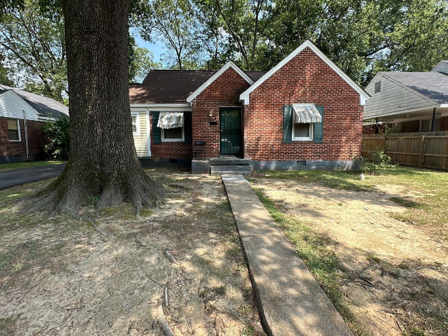 1590 Baltimore Street Memphis, TN 38114 - Photo 2 of 2 a front view of a house with a yard