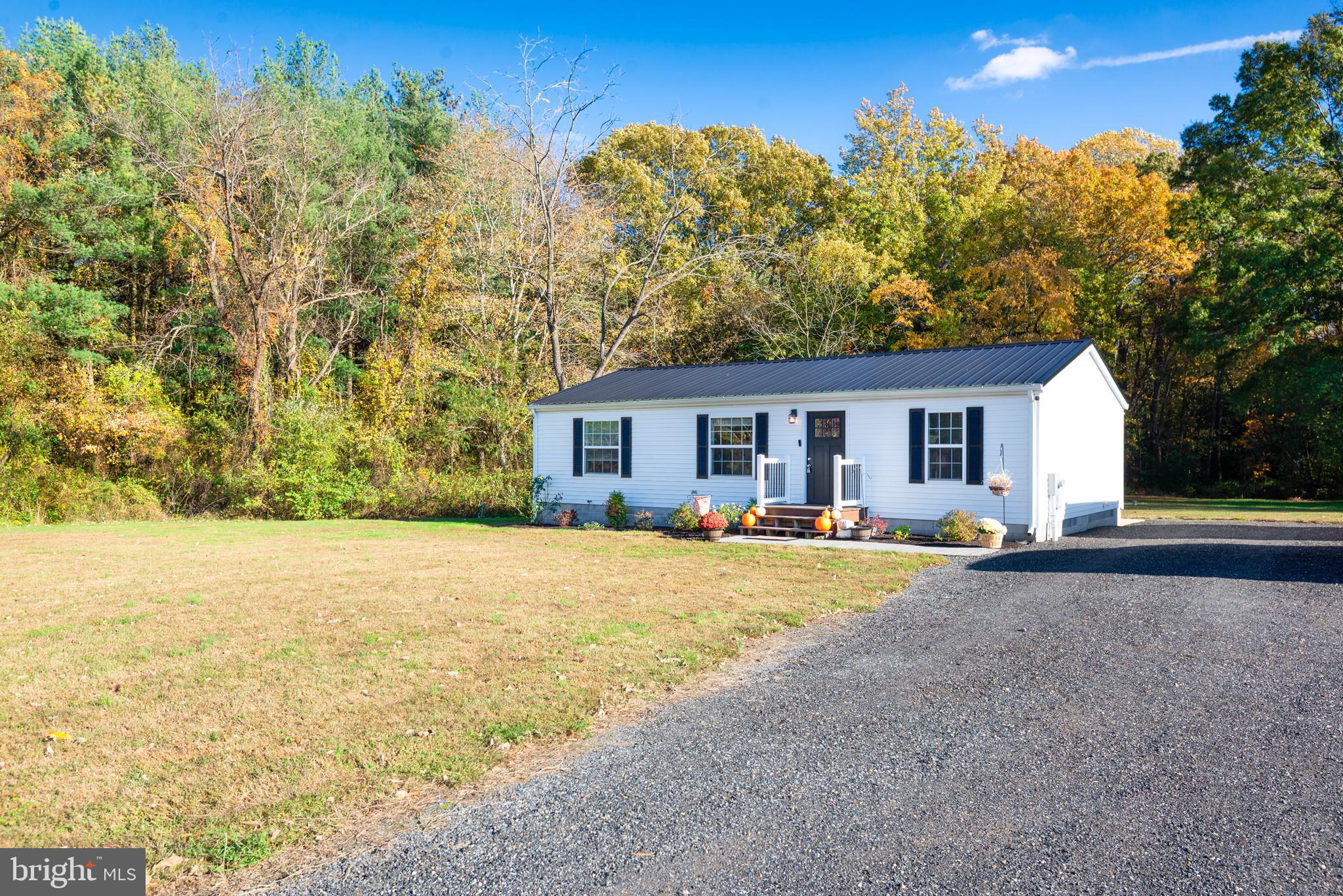 a view of a house with backyard and trees