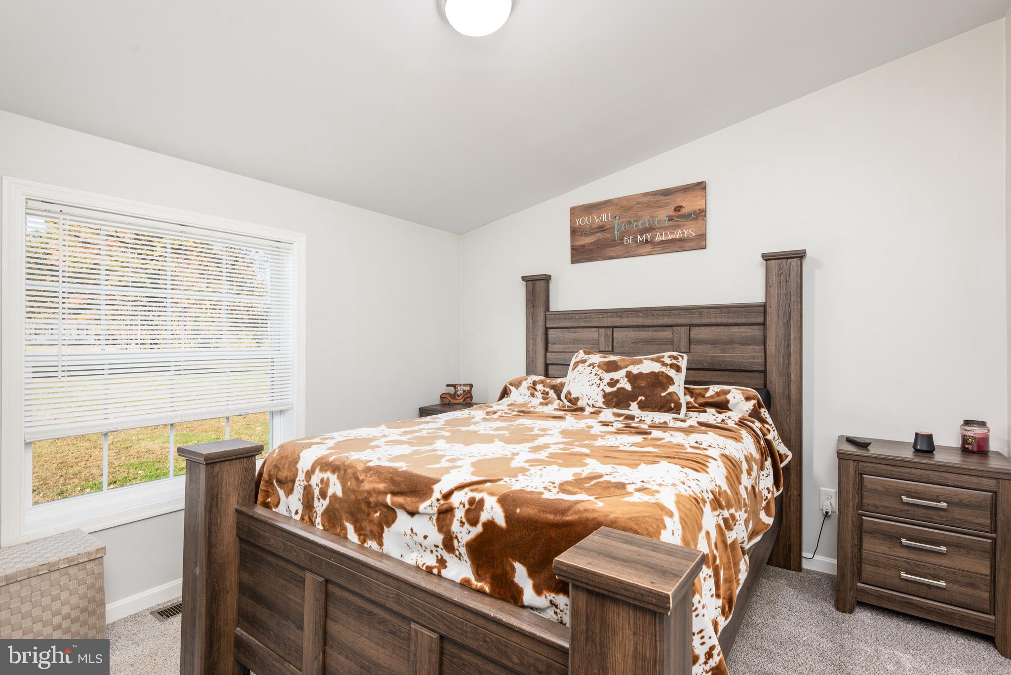 25607 Garey Road Denton, MD 21629 - Photo 12 of 19 a bed sitting in a bedroom next to a window