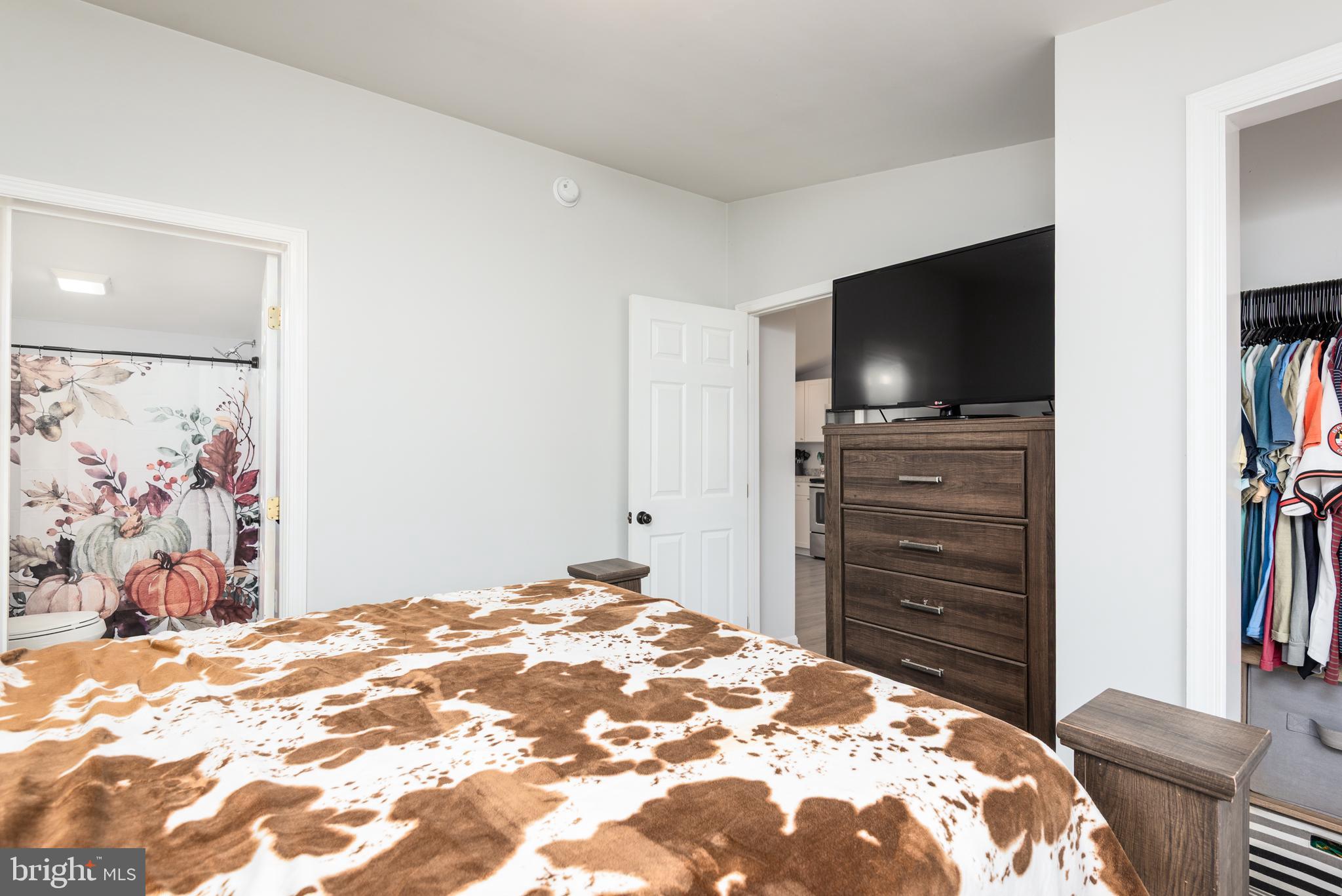 25607 Garey Road Denton, MD 21629 - Photo 13 of 19 a bedroom with a bed and a flat screen tv