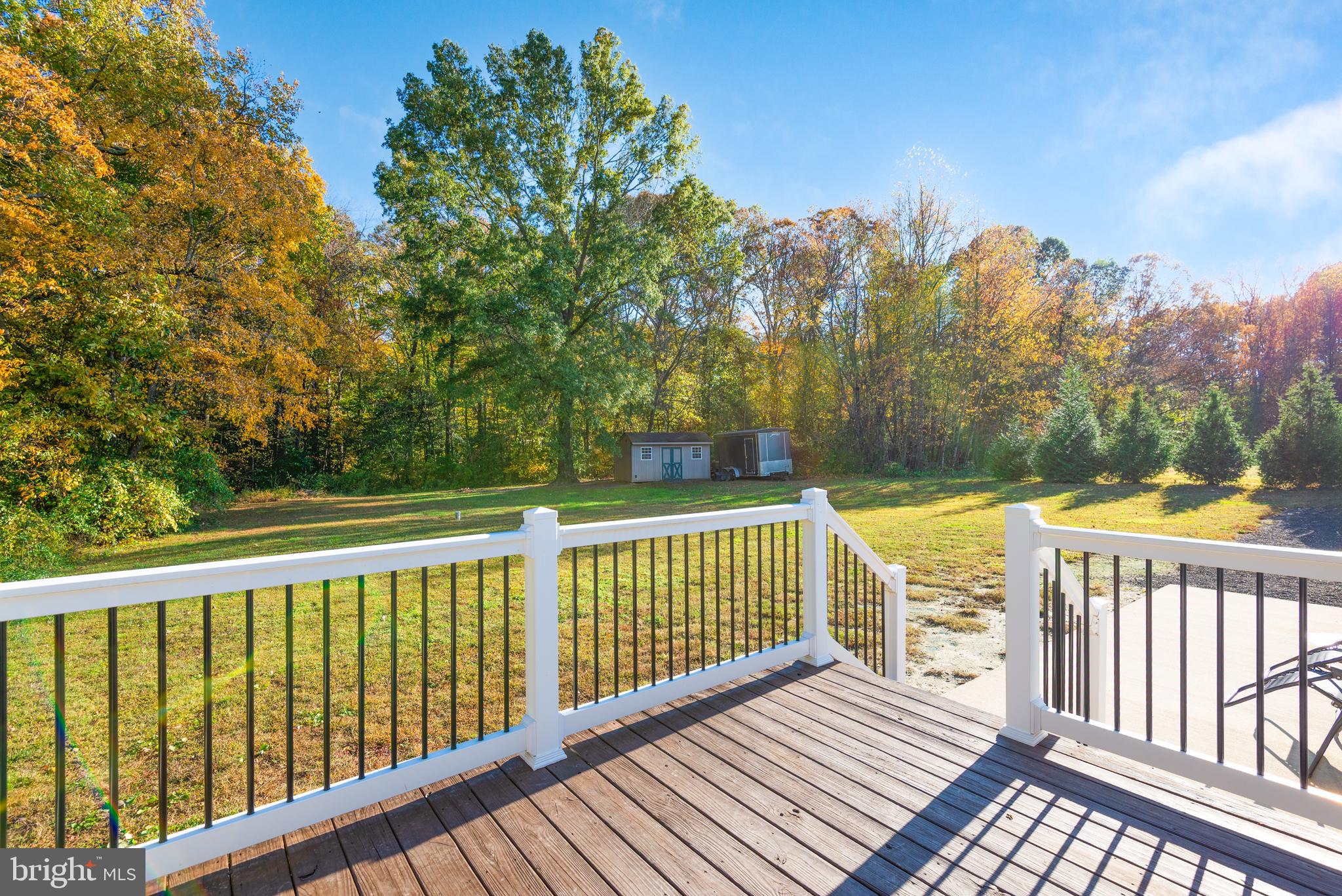 25607 Garey Road Denton, MD 21629 - Photo 19 of 19 a view of a wooden deck and a yard with swimming pool