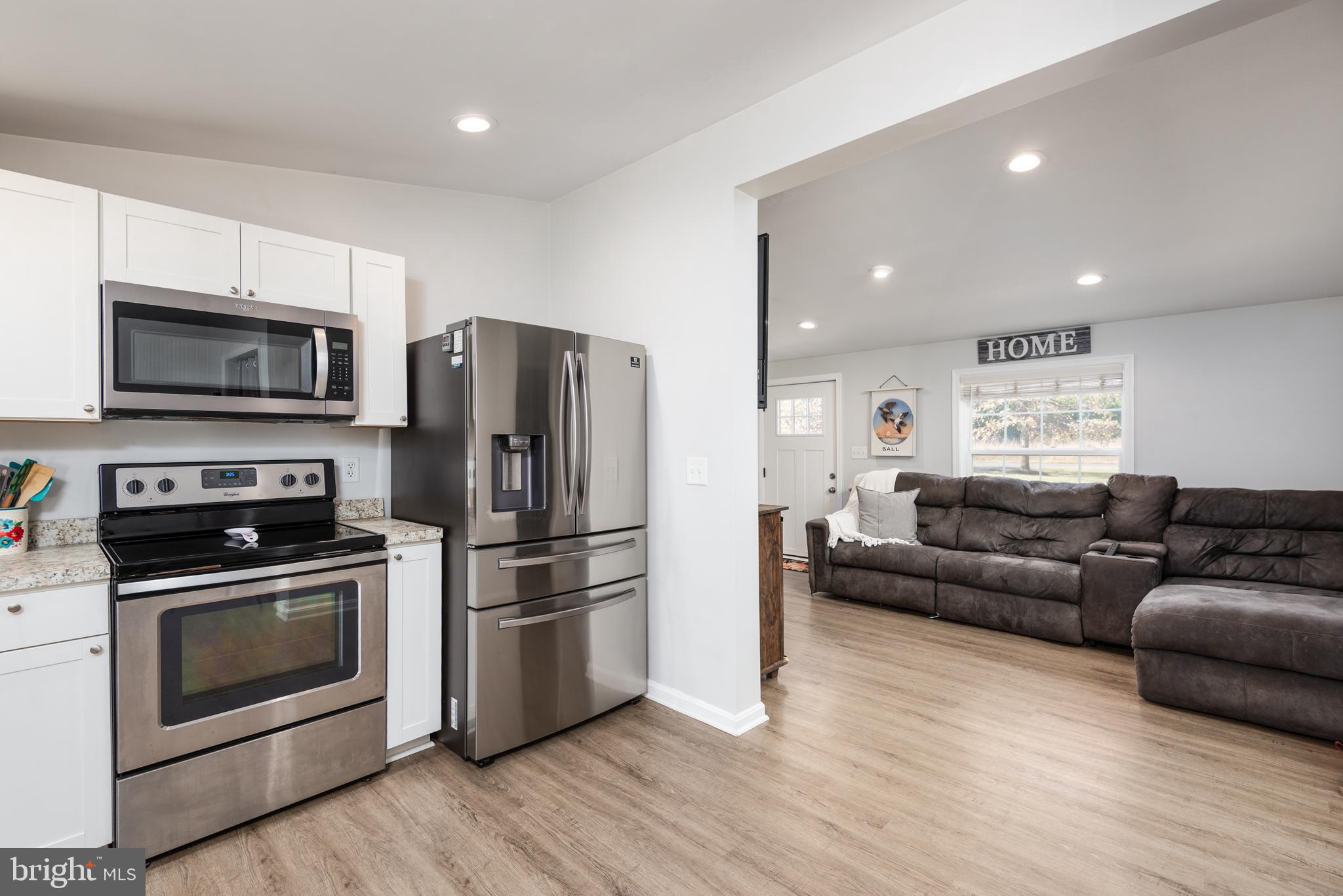 25607 Garey Road Denton, MD 21629 - Photo 7 of 19 a living room with furniture a flat screen tv and refrigerator