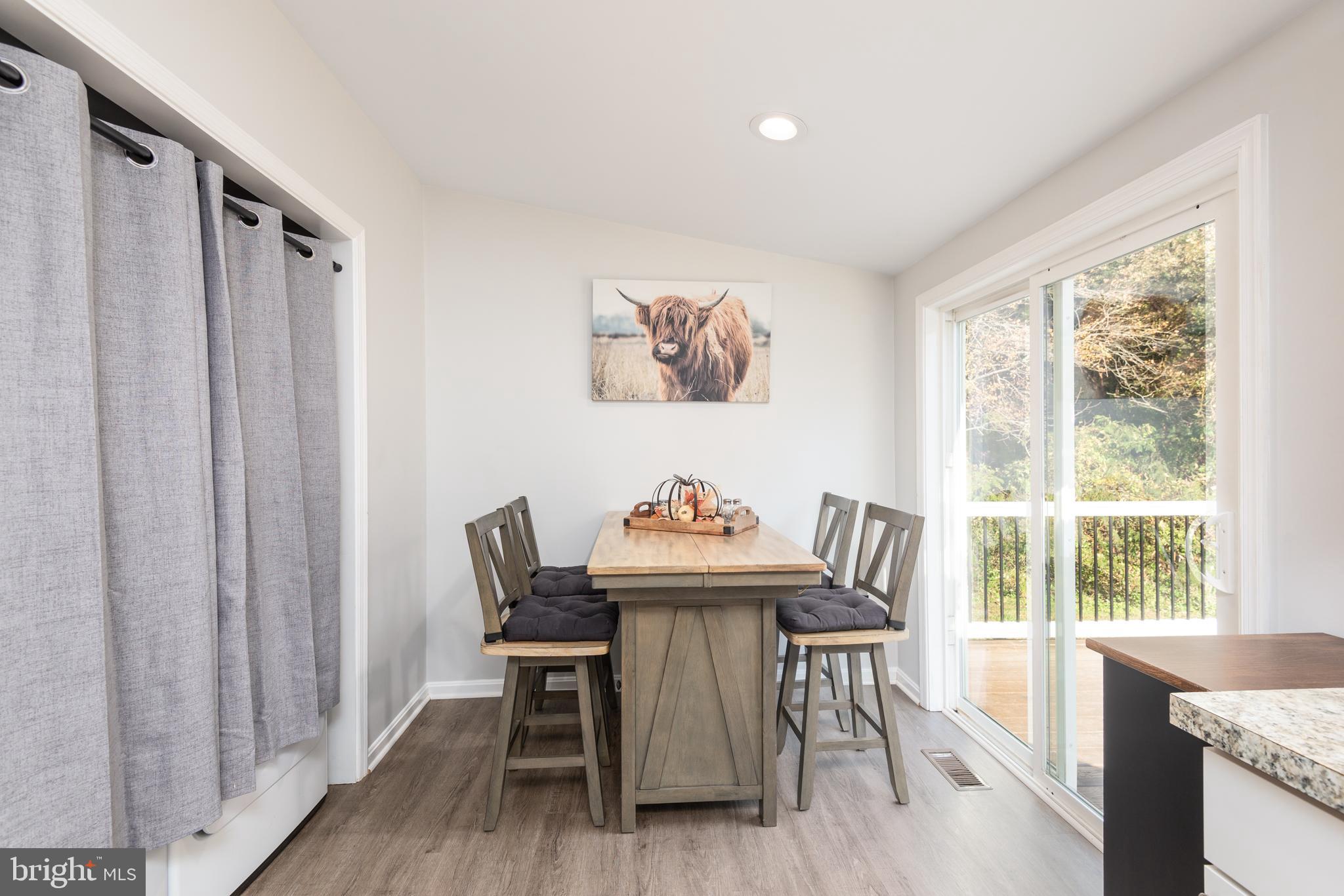 25607 Garey Road Denton, MD 21629 - Photo 10 of 19 a view of a dining room with furniture and wooden floor