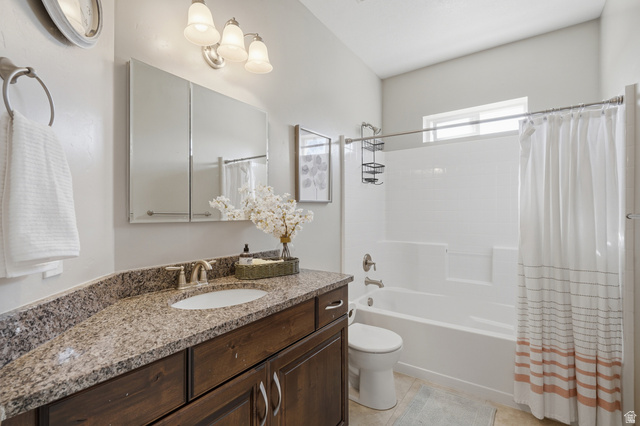 1997 East 600 South Springville, UT 84663 - Photo 31 of 54 Granite-style countertop with an undermount sink, wood-finish cabinetry, built-in medicine cabinet, and a shower-tub combination with a window