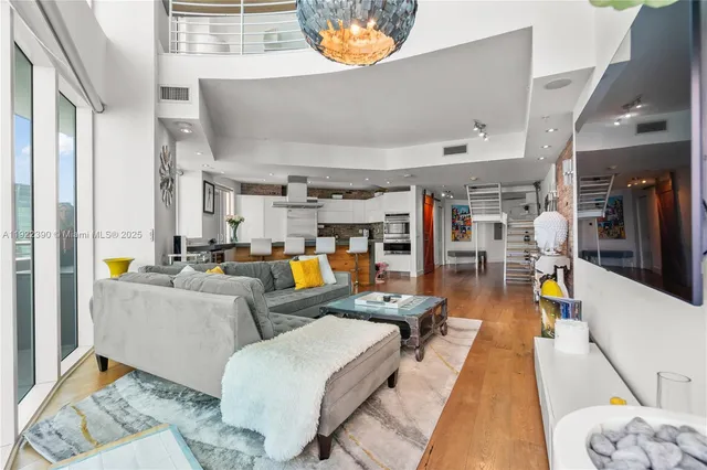 a living room with furniture and a chandelier