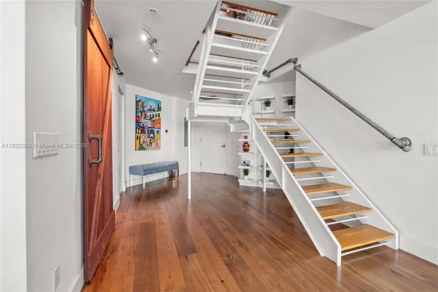 a view of entryway and hall with wooden floor