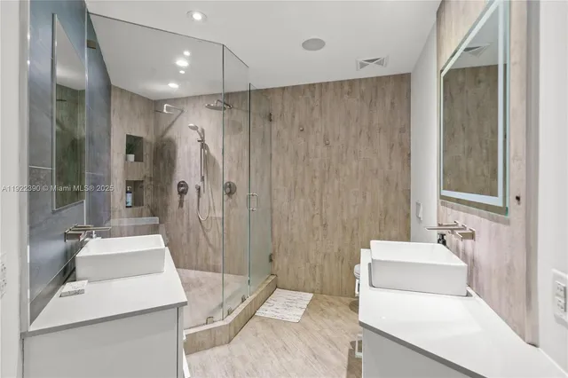 a view of walk in closet with clothes