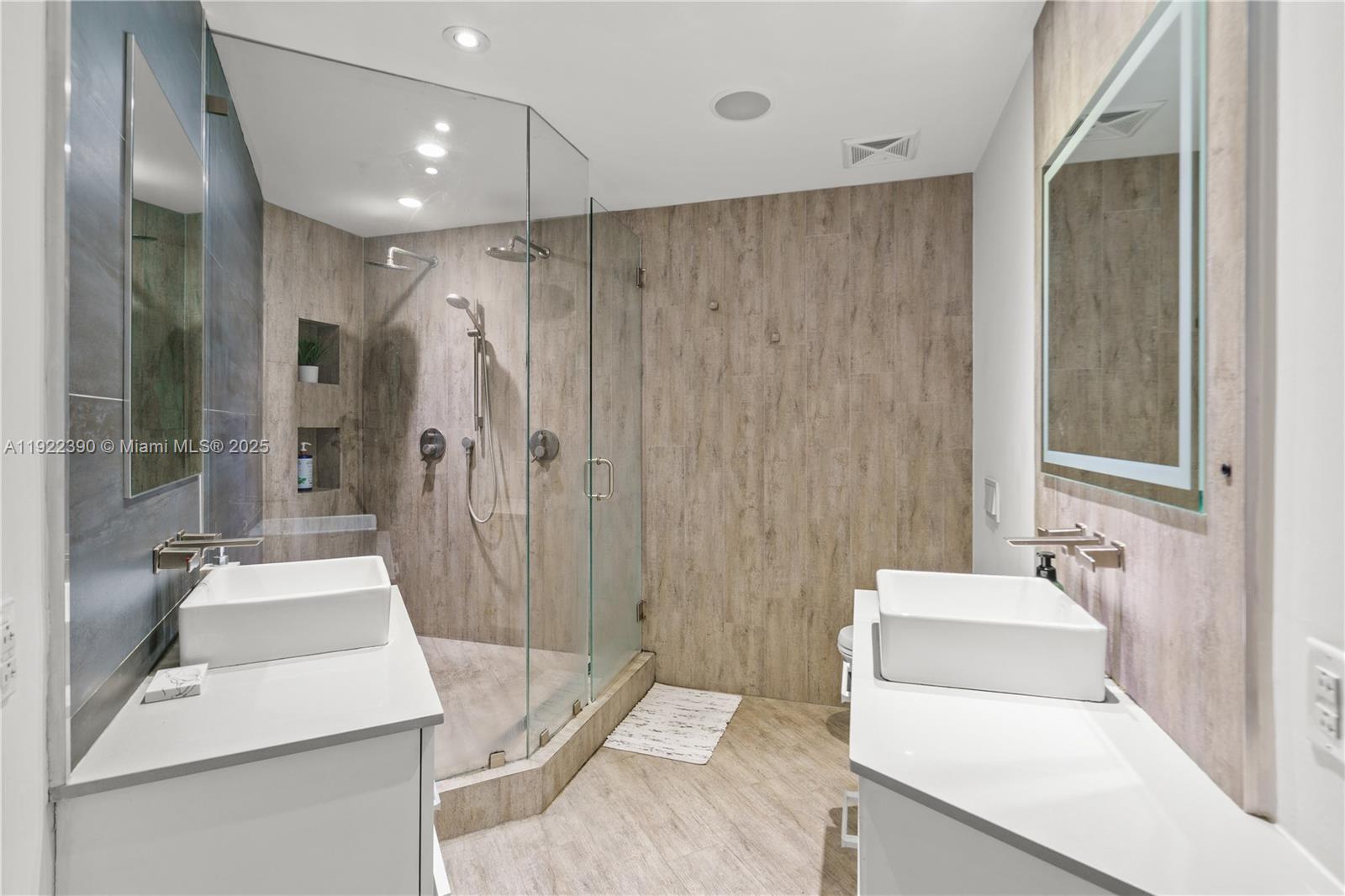 60 Southwest 13th Street, Unit 4616 Miami, FL 33130 - Photo 23 of 55 a bathroom with a sink a toilet and shower