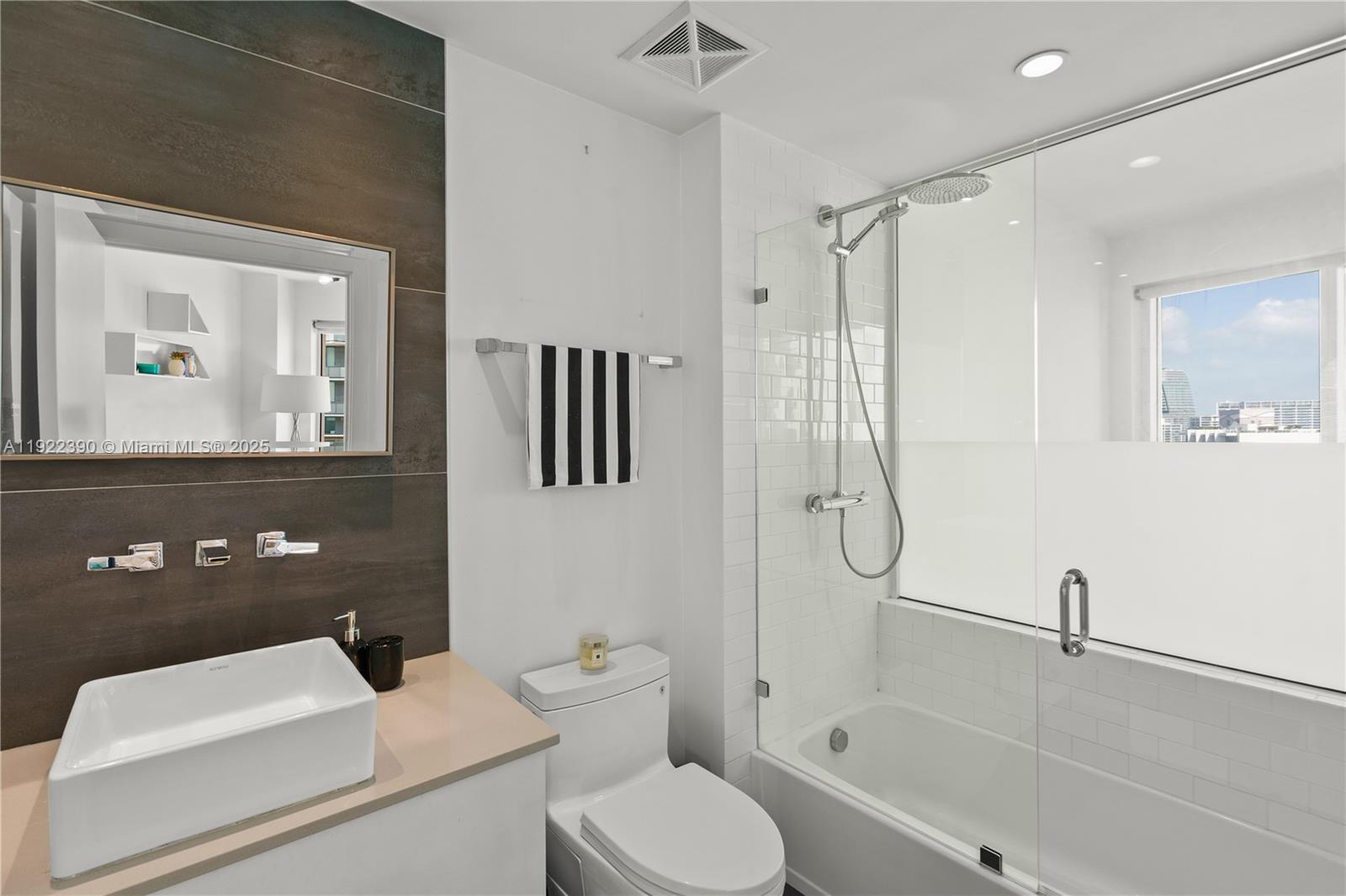 60 Southwest 13th Street, Unit 4616 Miami, FL 33130 - Photo 31 of 55 a bathroom with a toilet sink and shower