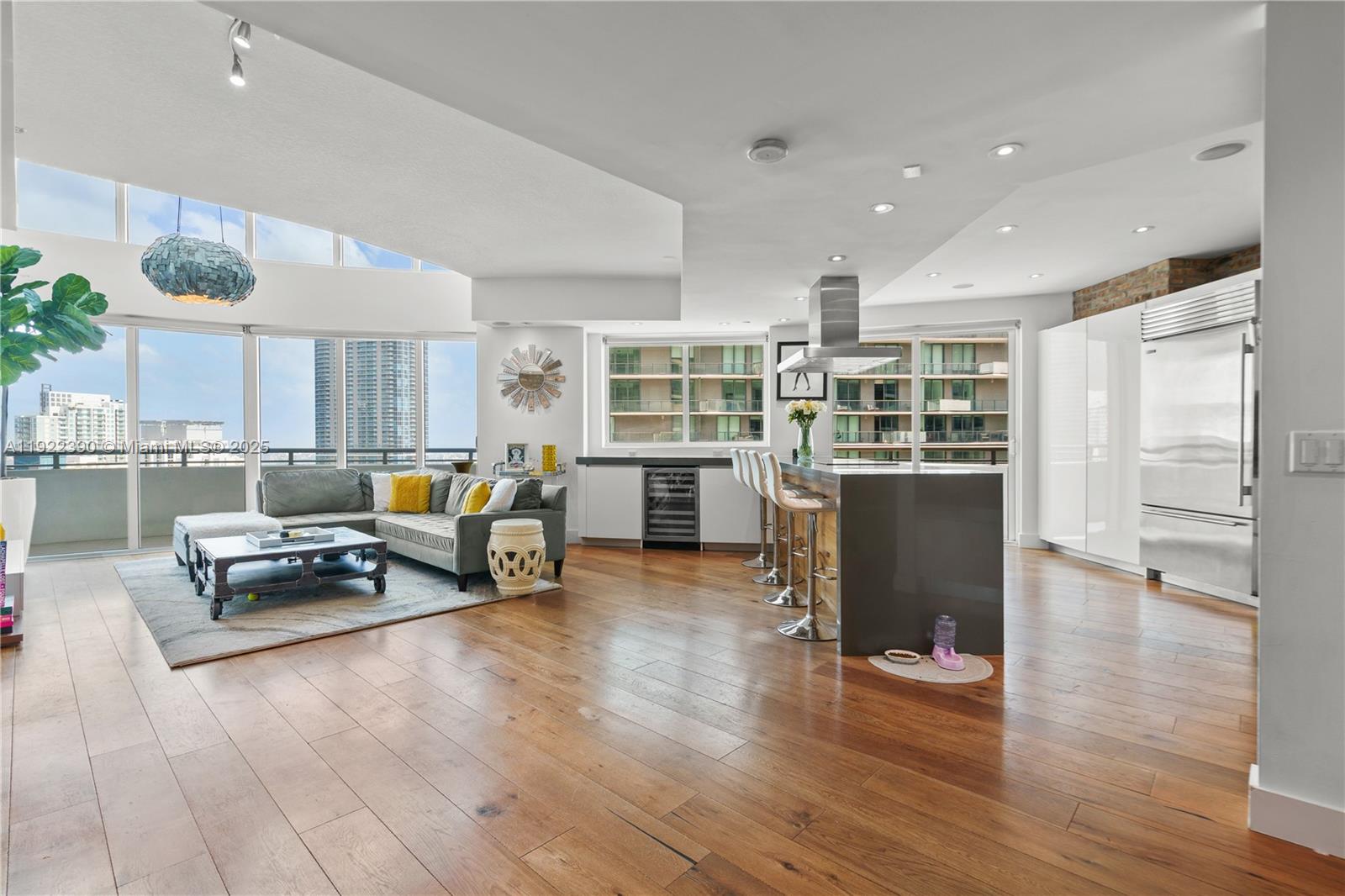 60 Southwest 13th Street, Unit 4616 Miami, FL 33130 - Photo 4 of 55 a living room with furniture and a wooden floor