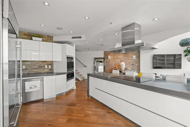 a kitchen with counter top space sink and stainless steel appliances