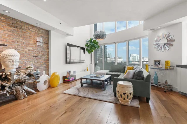 a living room with fireplace furniture and a wooden floor