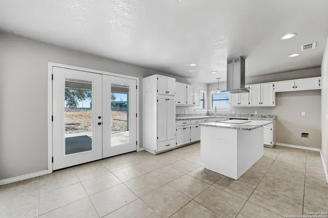 a kitchen with white cabinets and white appliances