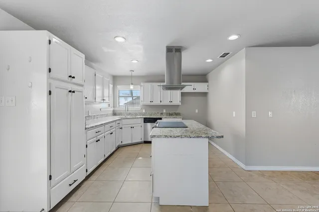 a kitchen with white cabinets