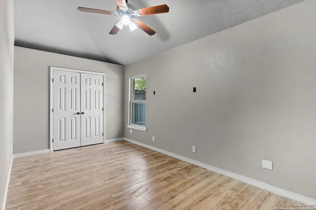 a view of an empty room with wooden floor