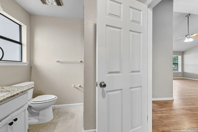 a white toilet sitting next to a bathroom sink