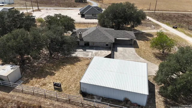 an aerial view of a house with a yard