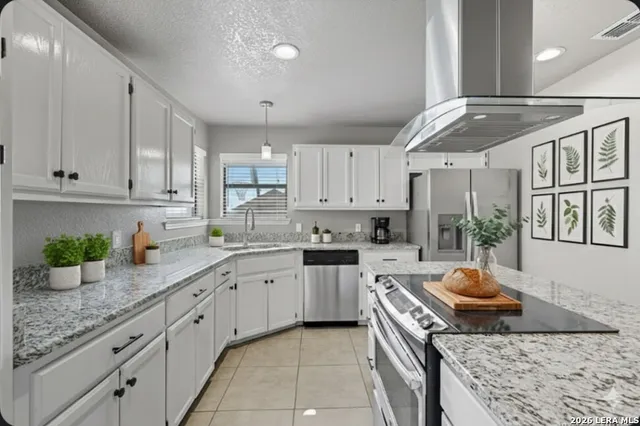 a kitchen with stainless steel appliances granite countertop a sink stove and cabinets