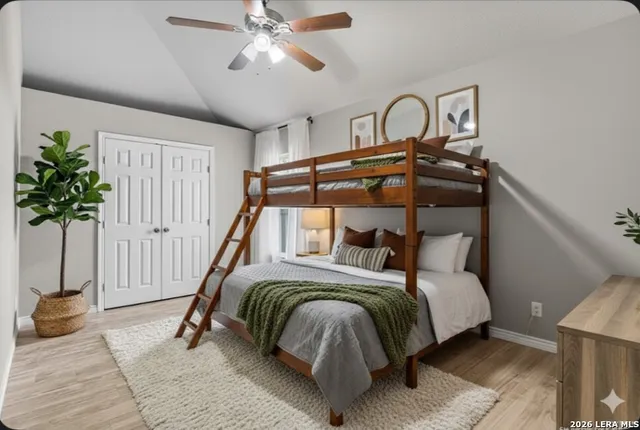 a bedroom with a bed and a potted plant on the dresser