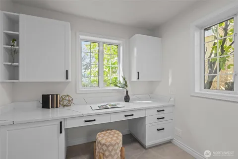 a kitchen with cabinets appliances and a window