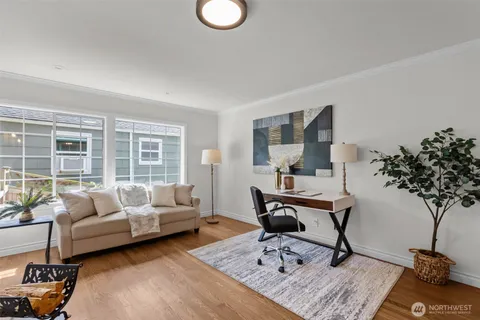 a living room with furniture and a potted plant