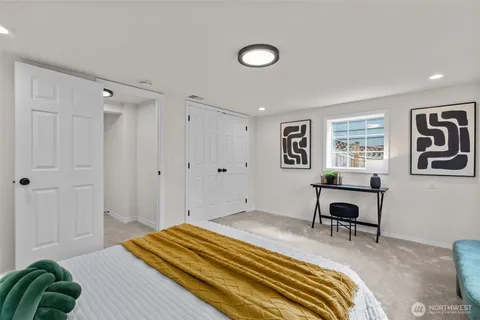 a bedroom with a bed and a workspace