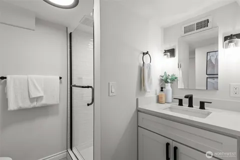 a bathroom with a sink a mirror and shower