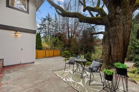 a view of patio with a table and chairs and potted plants