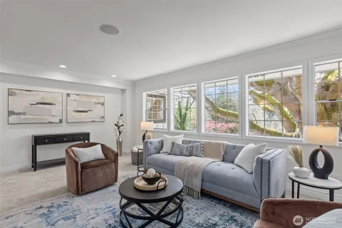 a living room with furniture fireplace and window