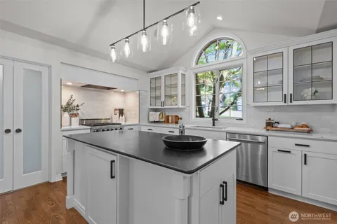 a kitchen with a sink a window and cabinets