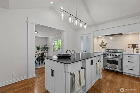 a kitchen with white cabinets and appliances