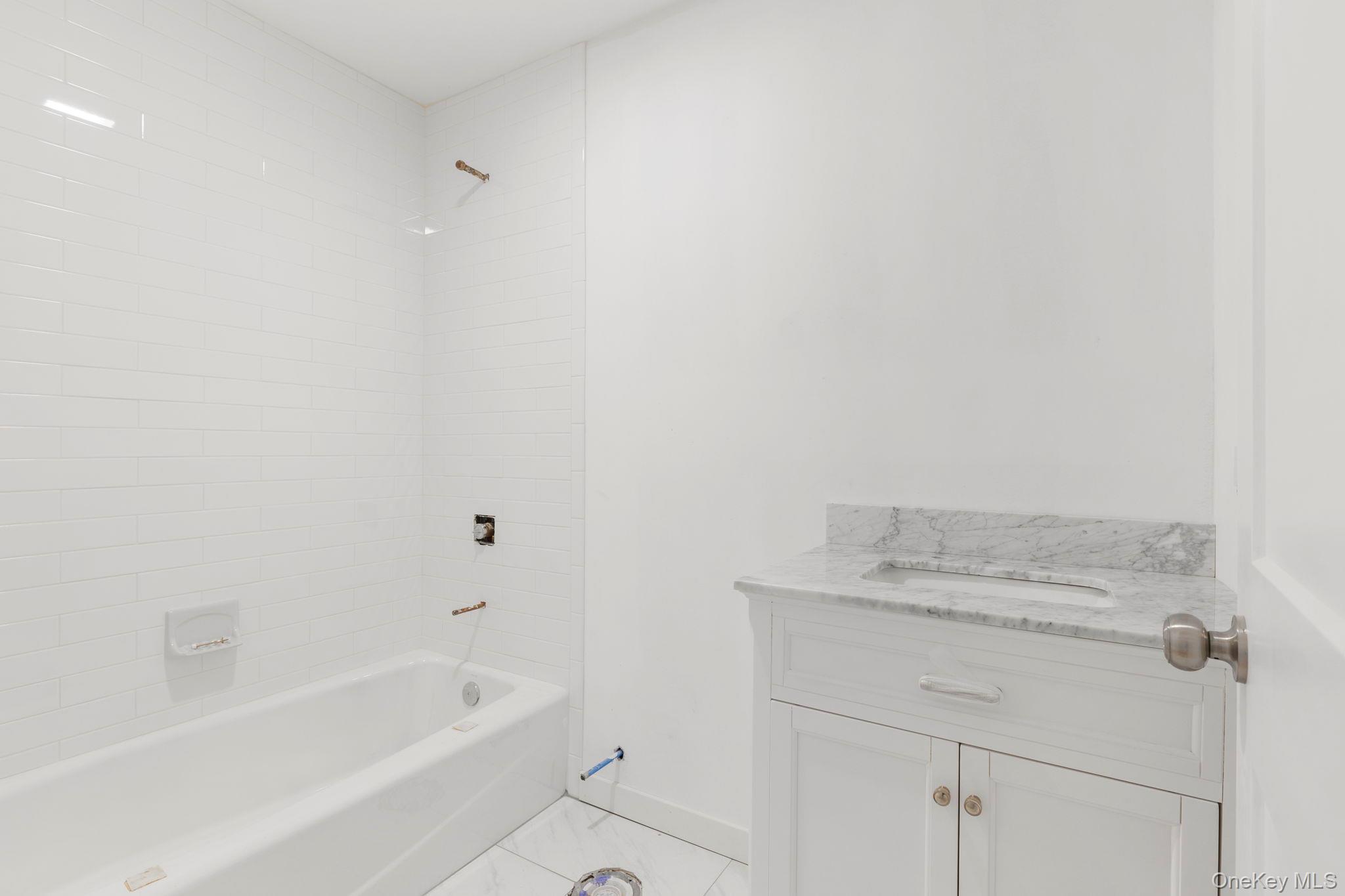 73 Farm To Market Road Brewster, NY 10509 - Photo 9 of 23 The to be built full hall bathroom will feature vanity and tub/shower combo-Picture depicts previously built similar home.Subject to change