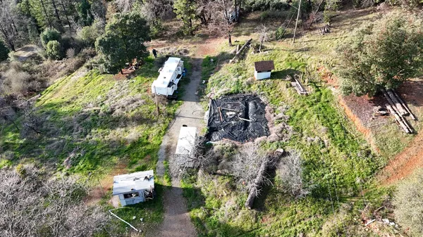 an aerial view of a house with a yard