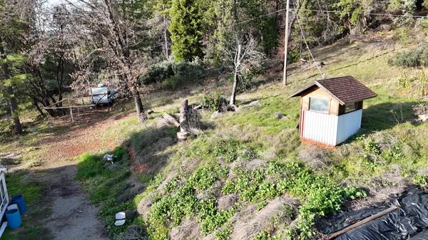 a view of a house with a yard and pathway