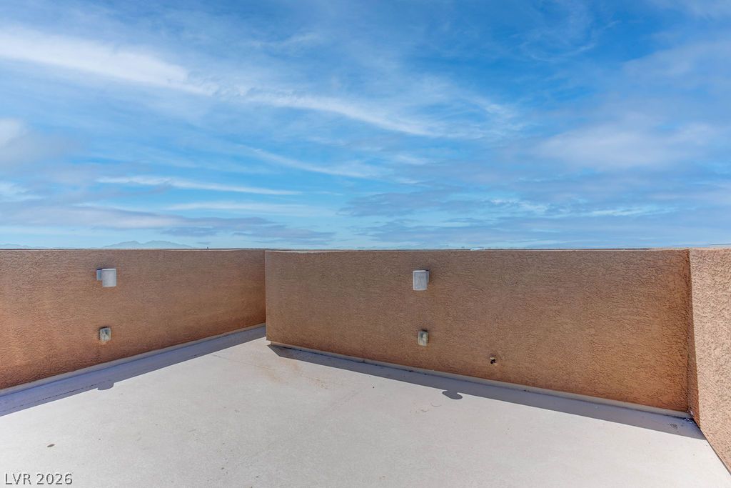 4650 Ranch House Road, Unit 47 North Las Vegas, NV 89031 - Photo 18 of 43 Vast, open-air terrace provides panoramic views of distant mountains under a dramatic sky.