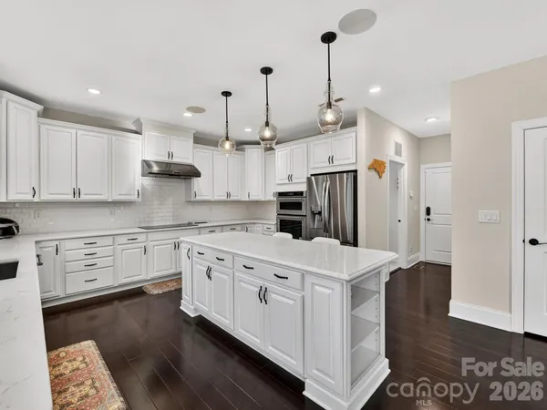 a large kitchen with kitchen island a sink and a stove