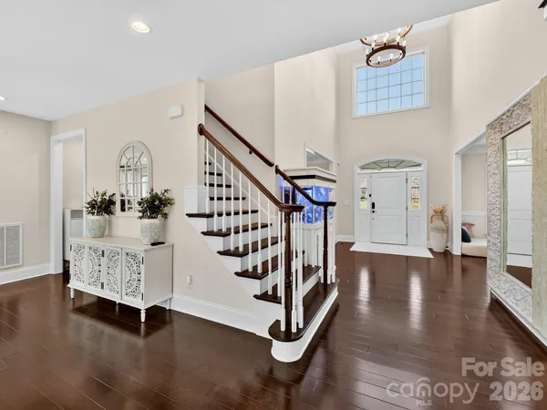 a dining room with furniture a chandelier and window