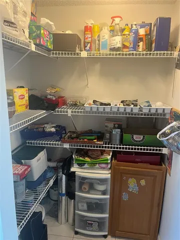 a picture of a room with racks on the wall and a stove