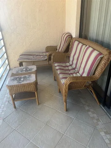 a living room with couches chairs and wooden floor