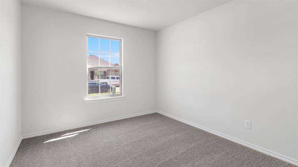 1913 Reveille Way Terrell, TX 75160 - Photo 23 of 35 Empty room with dark colored carpet and baseboards