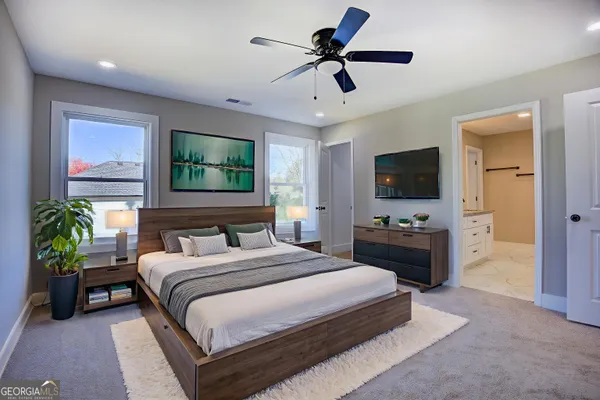 a bedroom with a bed a chandelier and a flat screen television