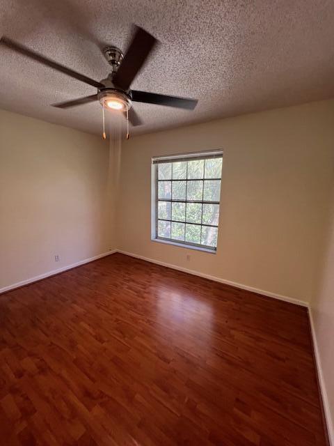 6800 Northeast 22nd Way, Unit 2132 Fort Lauderdale, FL 33308 - Photo 16 of 26 an empty room with wooden floor ceiling fan and windows