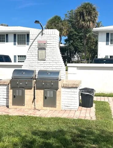 a view of house with yard and sitting area