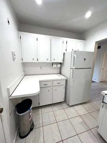 a kitchen with a stove sink and cabinets