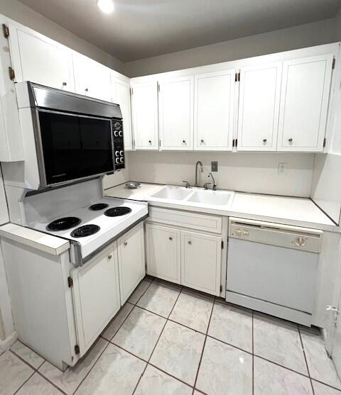 6800 Northeast 22nd Way, Unit 2132 Fort Lauderdale, FL 33308 - Photo 9 of 26 a kitchen with a stove sink and cabinets